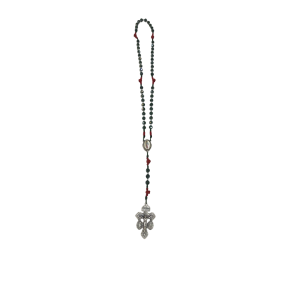 A long rosary with dark beads and red accents features an oval medallion and an ornate silver cross pendant at the end, against a white background.